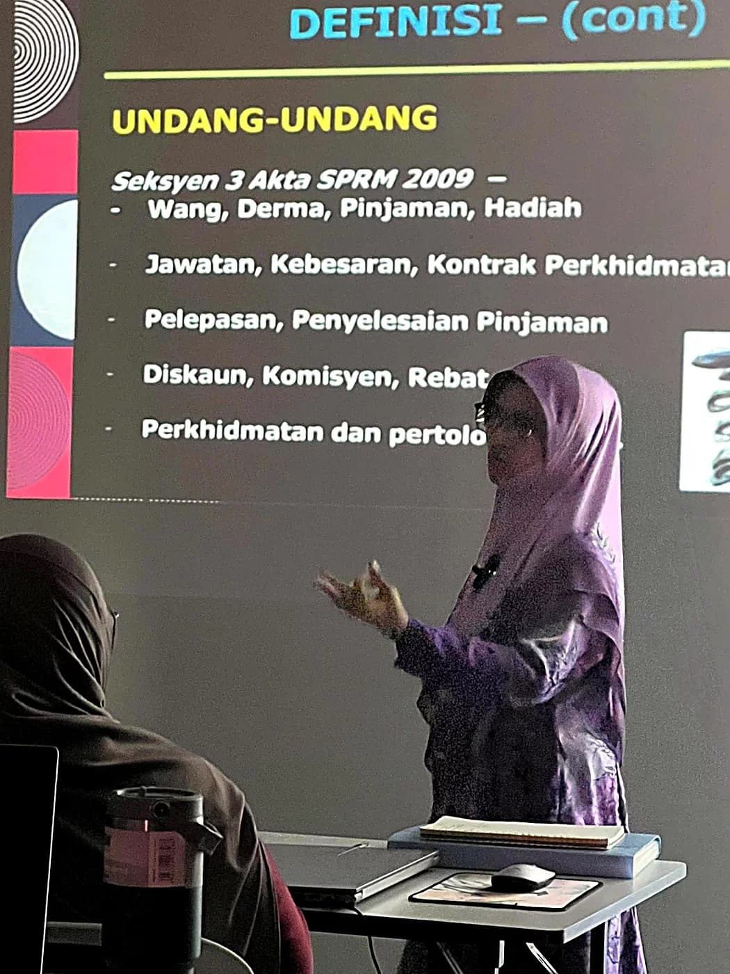 Trainer presenting a compliance and regulations session to the class