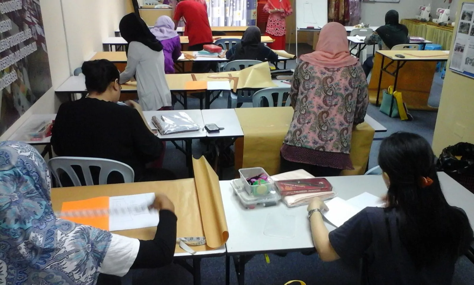 A small group working side by side in the academy classroom