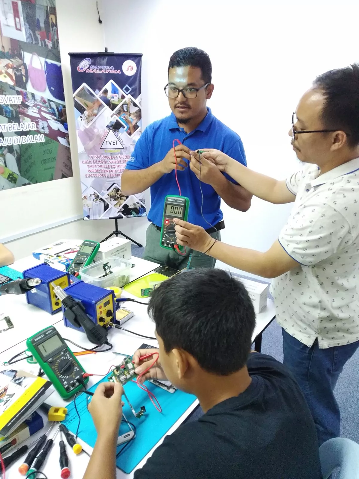 An instructor showing how to test a circuit with a multimeter