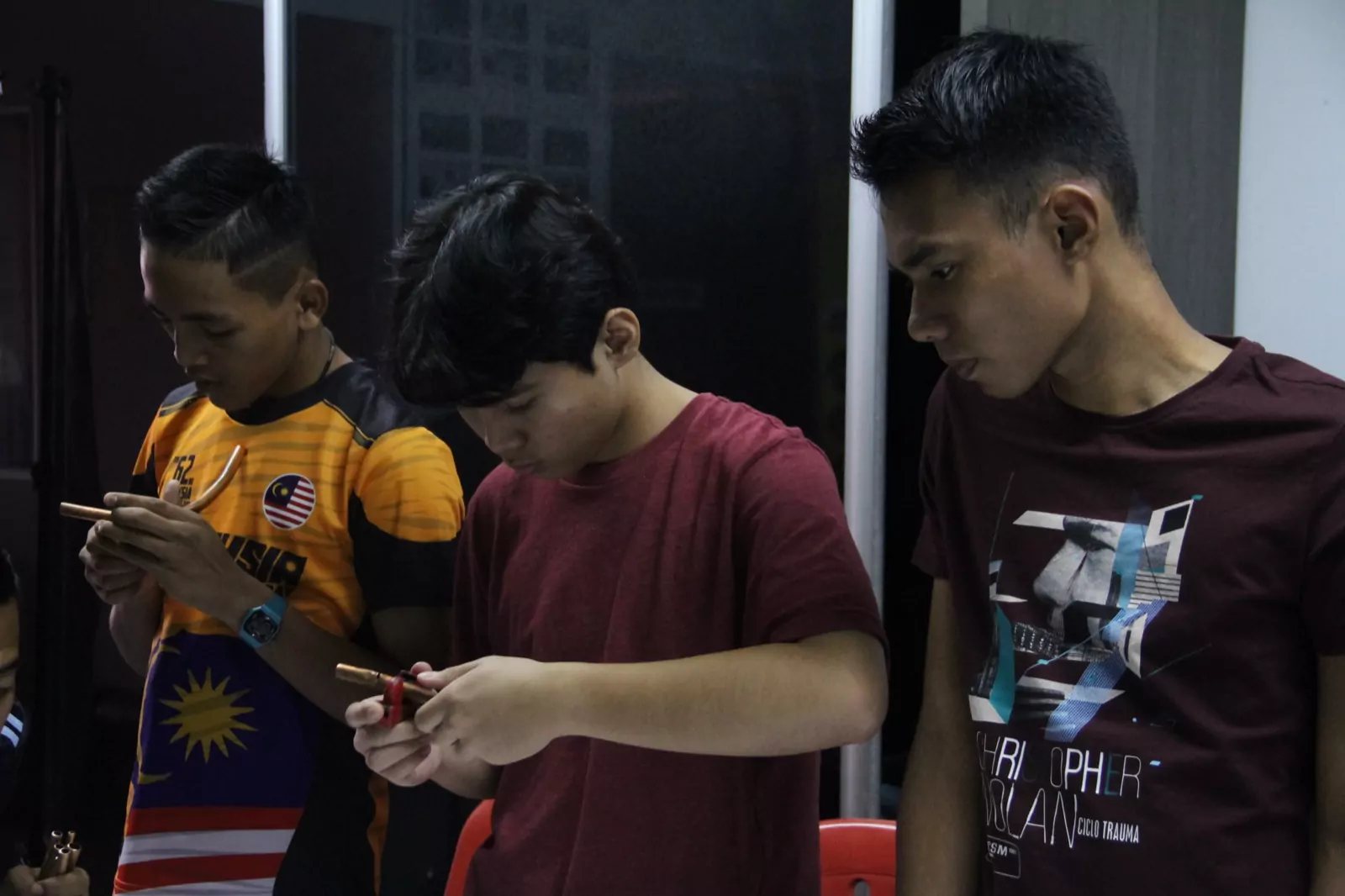 Students checking their phones between practical sessions